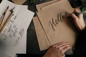 kaligrafija, krasnopis, calligraphy, brown-printer-paper-with-black-text-3826667 photo cottonbro from Pexels